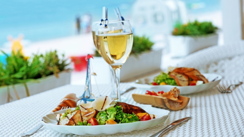 A glass of wine accompanies a summertime salad